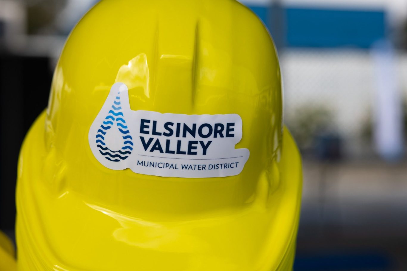 Corporate event photography Yellow hard hat with the Elsinore Valley Municipal Water District logo.